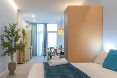 a bedroom with a bed and a dining room at PA20A - Loft Valencia in Valencia