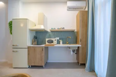 a small kitchen with a refrigerator and a sink at PA20A - Loft Valencia in Valencia
