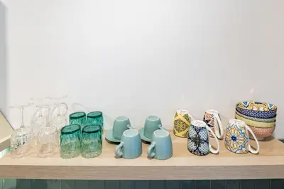 a shelf with glass vases and bowls on it at PA20A - Loft Valencia in Valencia