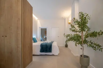 a bedroom with a bed and a potted tree in it at PA20A - Loft Valencia in Valencia