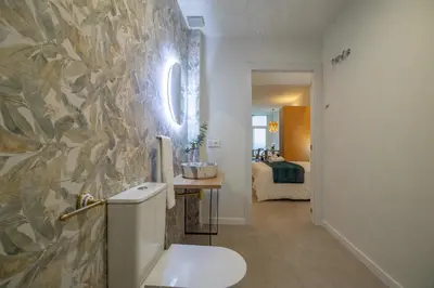 a bathroom with a white toilet and a bedroom at PA20A - Loft Valencia in Valencia