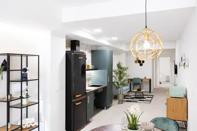 a kitchen and living room with a black refrigerator at AG7 Loft Valencia Espaciosos estudios con terraza cercanos al metro Zona Ayora in Valencia