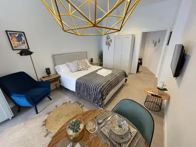 a bedroom with a bed and a table and chairs at PALX Loft Valencia - Estudio contemporáneo cerca de las Artes y las Ciencias in Valencia