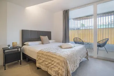 a bedroom with a bed and a large window at PALX Loft Valencia - Estudio contemporáneo cerca de las Artes y las Ciencias in Valencia