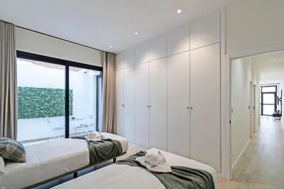 a bedroom with two beds and a large window at GuestReady - Urban elegance in Valencia in Valencia