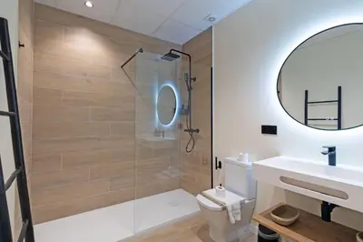 a bathroom with a toilet and a sink and a mirror at GuestReady - Urban elegance in Valencia in Valencia
