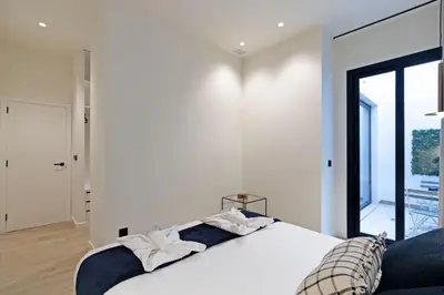 a bedroom with a large white bed with a window at GuestReady - Urban elegance in Valencia in Valencia