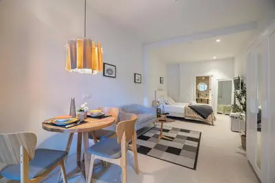 a living room with a table and a room with a bed at PM - Loft Valencia Espaciosos estudios con terraza cerca a las Artes y las Ciencias in Valencia