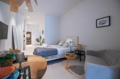 a living room with a bed and a couch at LO - Loft Valencia - Modernos y acogedores estudios cerca a las Artes y las Ciencias in Valencia