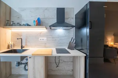 a kitchen with a sink and a refrigerator at LO - Loft Valencia - Modernos y acogedores estudios cerca a las Artes y las Ciencias in Valencia