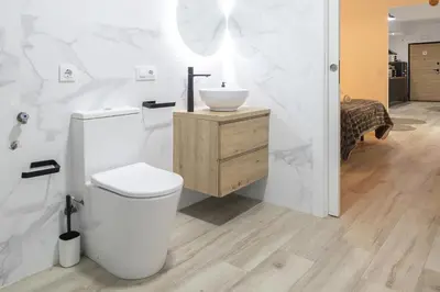 a white bathroom with a toilet and a sink at LN4 - Loft Valencia Espacioso y acogedor estudio cerca del metro zona Ayora in Valencia