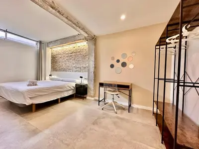 a bedroom with a bed and a desk at Turia Gardens & Science & Center in Valencia