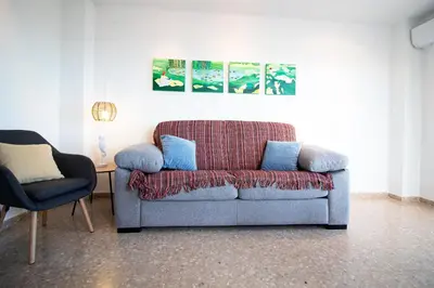 a living room with a couch and two chairs at Global Vacacional, Apartamento de 3 habitaciones en urbanización cerca del mar in Canet de Berenguer