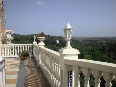 a white balcony with a street light on it at La Casa de la Cascada in Anna