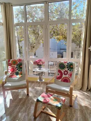 a living room with two chairs and a large window at La Casa de la Cascada in Anna
