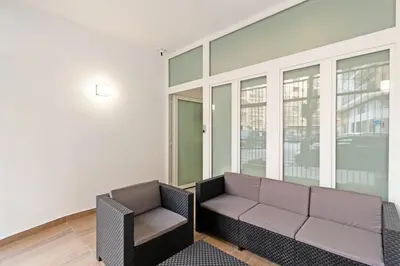 a living room with a couch and a chair at GuestReady - A lovely studio in la Saidia Valencia in Valencia