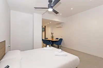 two beds in a room with a table and chairs at GuestReady - A lovely studio in la Saidia Valencia in Valencia
