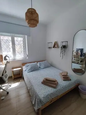 a bedroom with a bed and a large mirror at Apartamento al lado de la playa Malvarrosa in Valencia