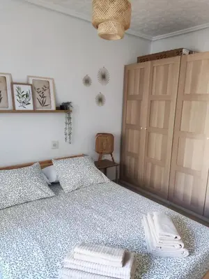 a bedroom with a bed with two towels on it at Apartamento al lado de la playa Malvarrosa in Valencia