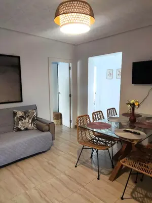 a living room with a couch and a table and chairs at Apartamento al lado de la playa Malvarrosa in Valencia