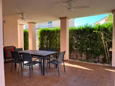 a black table and chairs on a patio at Casa Platja Mareny Blau in Mareny Blau