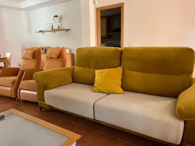 a couch with yellow pillows on it in a living room at Casa Platja Mareny Blau in Mareny Blau