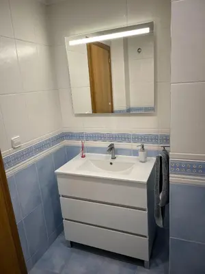 a bathroom with a white sink and a mirror at Casa Platja Mareny Blau in Mareny Blau