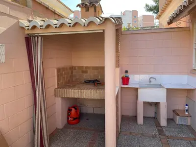 an outdoor kitchen with a sink and a sink at Casa Platja Mareny Blau in Mareny Blau