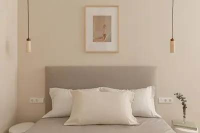 a white bedroom with a bed with white pillows at MH Apartments Central Valencia in Valencia