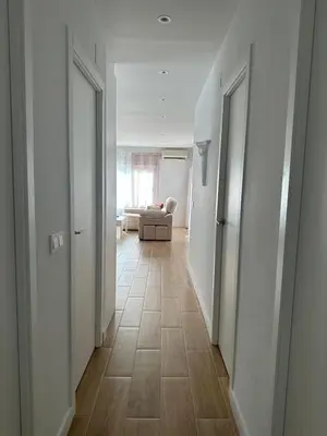 an empty hallway with a couch in the middle of a room at La Casita in La Eliana