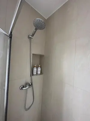 a shower with a shower head in a bathroom at La Casita in La Eliana