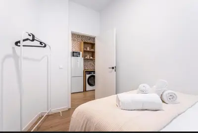a white bedroom with a bed with towels on it at Lugre, Lovely flat close to center in Valencia