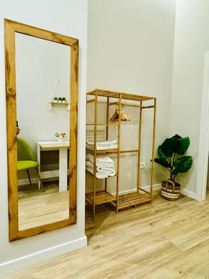 a mirror in a room with a table and a desk at Stylish Design Studio in Valencia in Valencia