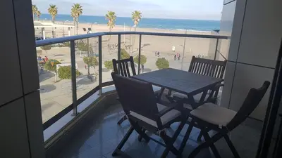 a table and chairs on a balcony with a view of the beach at Direct view to the beach , Parking , Terraza in Valencia