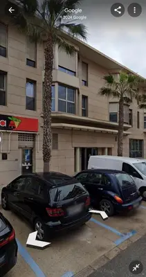 two cars parked in a parking lot in front of a building at Direct view to the beach , Parking , Terraza in Valencia
