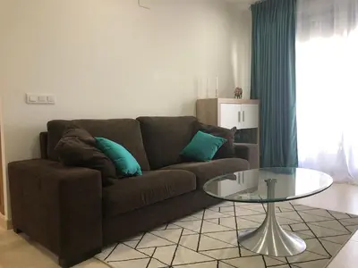a living room with a couch and a glass table at Direct view to the beach , Parking , Terraza in Valencia