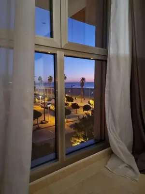 a room with a window looking out at the ocean at Direct view to the beach , Parking , Terraza in Valencia