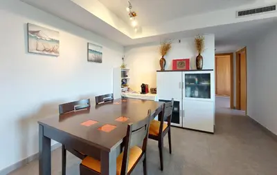a kitchen and dining room with a table and chairs at Cozy Apartment In Moncofa in Moncófar