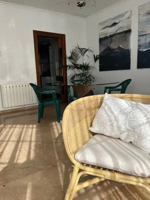 a chair with a pillow on it in a room at Casa Dani in Sueca