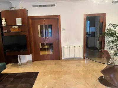 a living room with a glass table and a tv at Casa Dani in Sueca