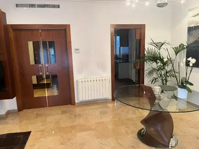 a living room with a glass table and a door at Casa Dani in Sueca