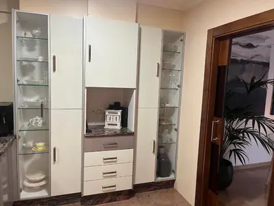 a white closet with drawers and shelves at Casa Dani in Sueca