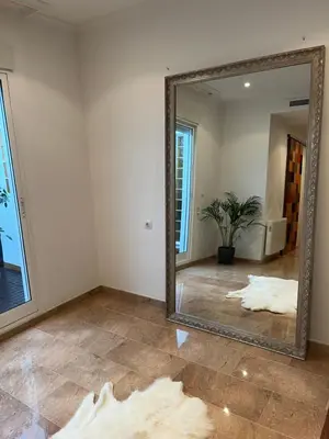 a large mirror in a room with a tile floor at Casa Dani in Sueca
