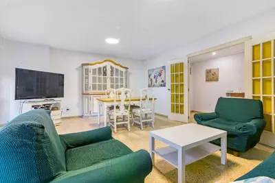 a living room with a couch and a table at Centrally located temporary, very spacious Pataconabluerentals in Valencia