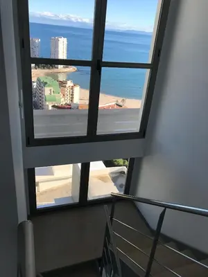 a view of the ocean from a window in a building at Villa conectada al mediterraneo, Infinity pool in Faro de Cullera