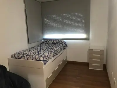 a small bedroom with a bed and a window at Villa conectada al mediterraneo, Infinity pool in Faro de Cullera