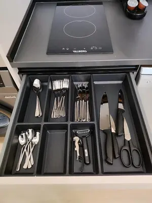 a black drawer filled with utensils in a kitchen at Apartamento RD C in Valencia