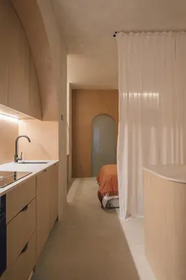 a kitchen with a shower and a bed in a room at Oasis suites ruzafa in Valencia