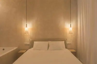 a bedroom with a bed with two lights above it at Oasis suites ruzafa in Valencia