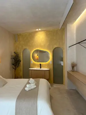 a hotel room with a bed and a mirror at Oasis suites ruzafa in Valencia